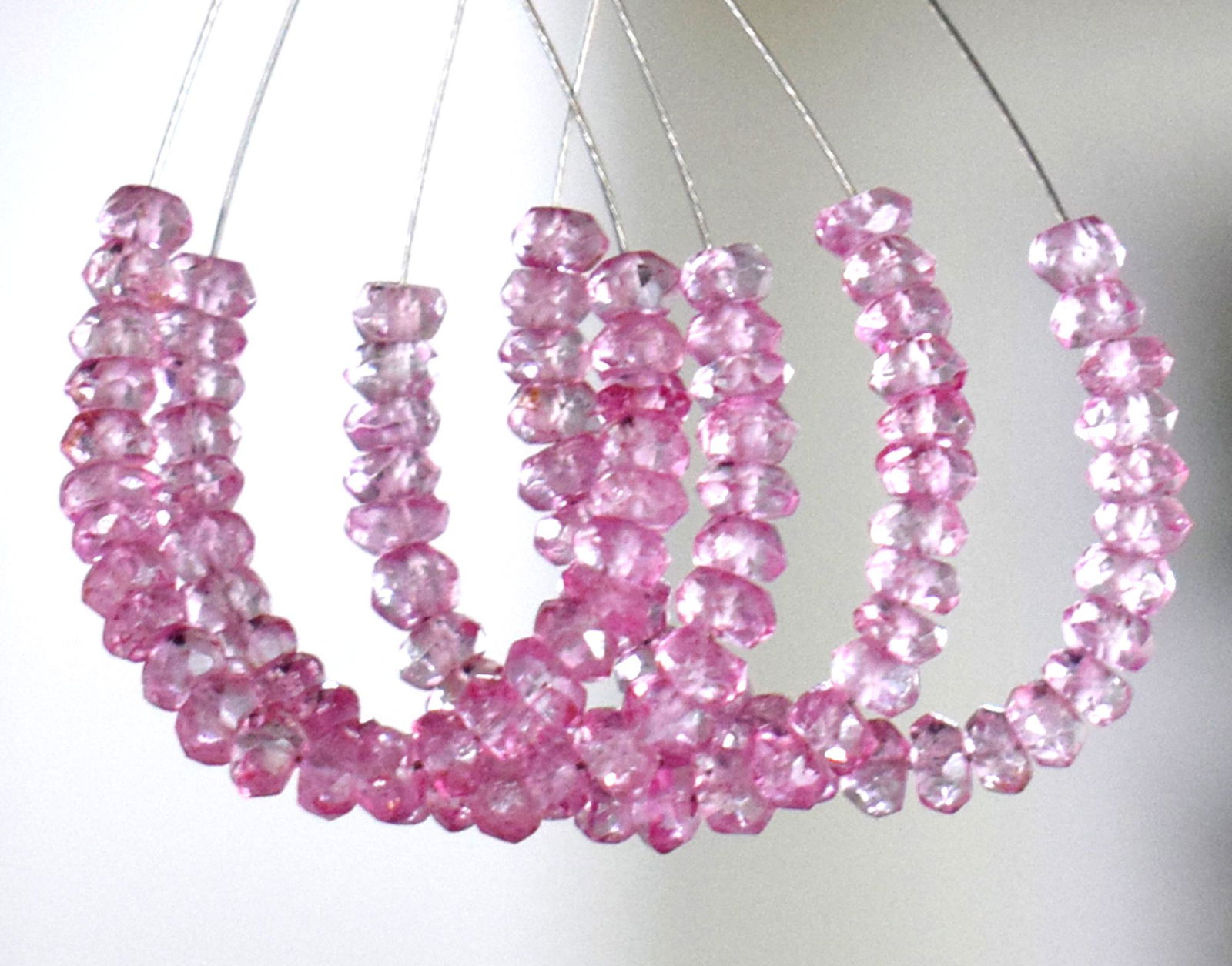 4 TASSEL - PINK TOPAZ - RONDELLE 3.5 MM: TASSEL- means the drilled pieces of gemstones are loosely attached with a wire , ideally you can use it to create of of a kind jewelry . STONE : NATURAL GEM QUALITY PINK TOPAZ (COATED) FACETED RONDELL