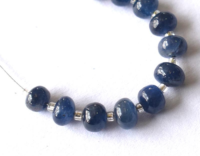 BURMEESE SAPPHIRE - RONDELLES - 5 mm - TASSEL: " TASSEL"- means the drilled pieces of gemstones are loosely attached with a wire , ideally you can use it to create of of a kind jewelry . STONE : NATURAL EARTH MINED BURMEESE BLUE SAPPHIRE RONDELLE 
