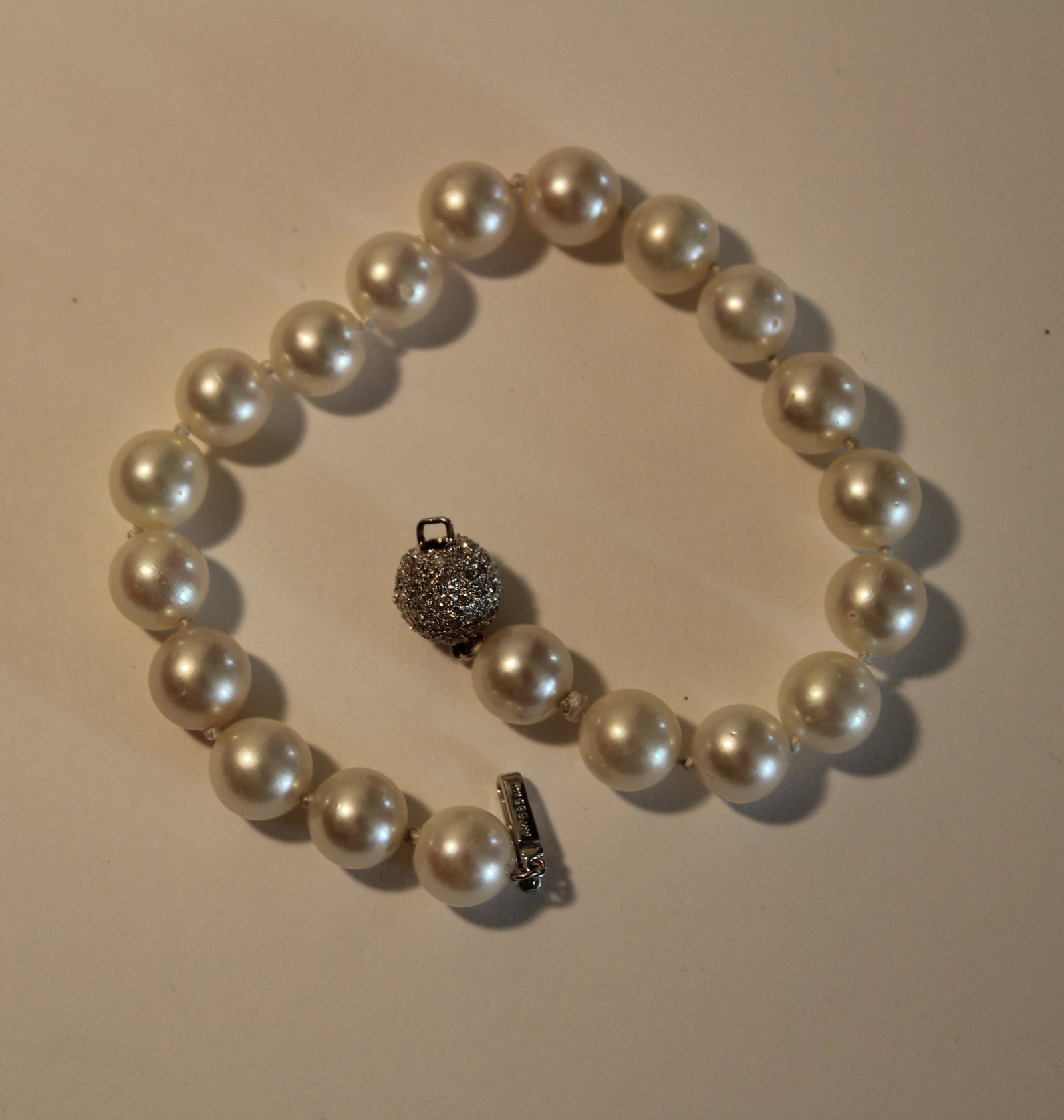 14K DIAMOND PEARL BRACELET: Pearl bracelet with a 14k white gold diamond ball clasp. Bracelet measures 8 inches long. Clasp is 10mm and pearls 8mm.
