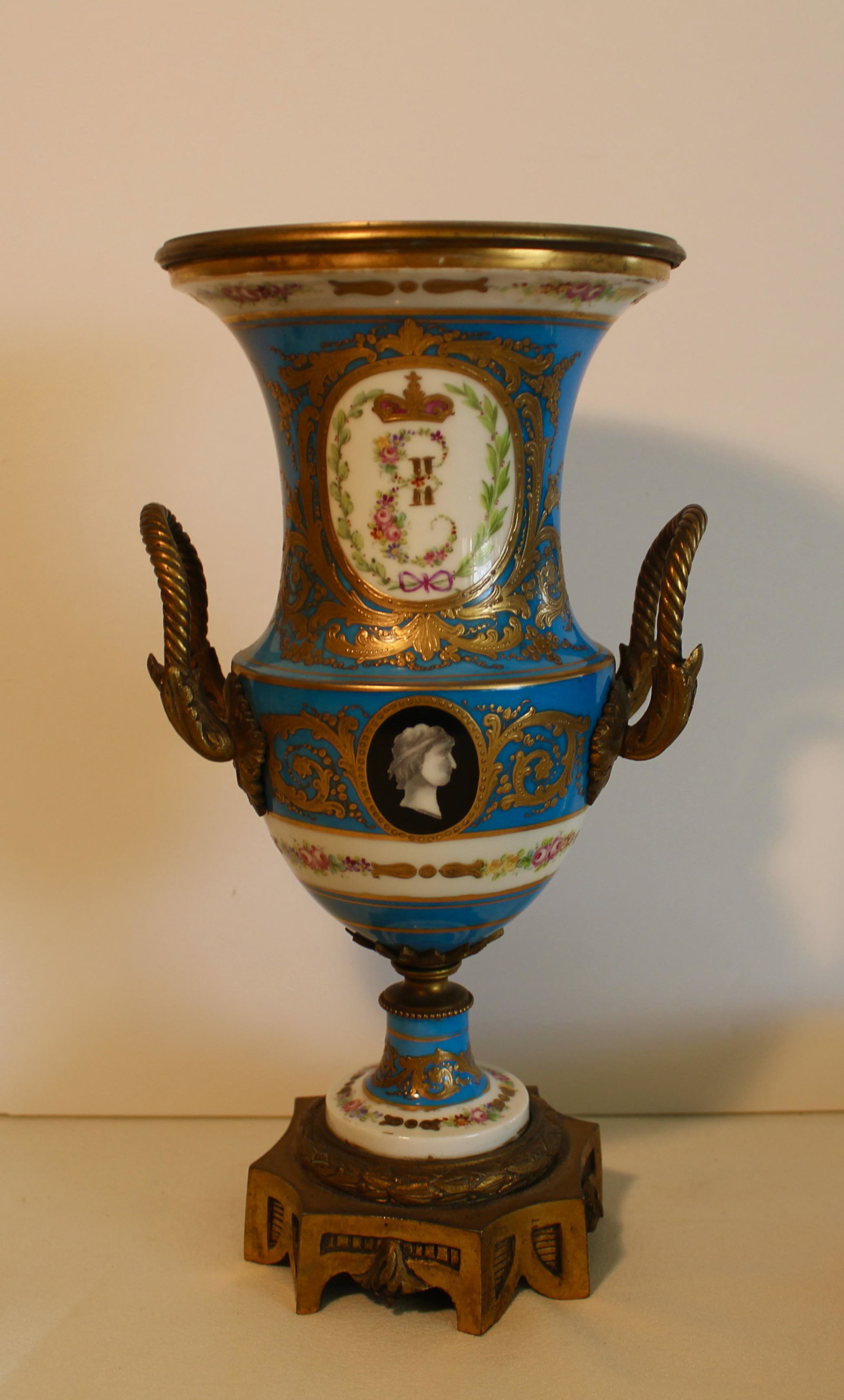 SEVRES RUSSIAN CATHERINE THE GREAT VASE: Sevres vase in celeste blue decorated with Catherine the Great of Russia monogram on the front and colorful flower bouquet on the back. Raised gold gilding and flowers in pattern of the Sevres dinner 