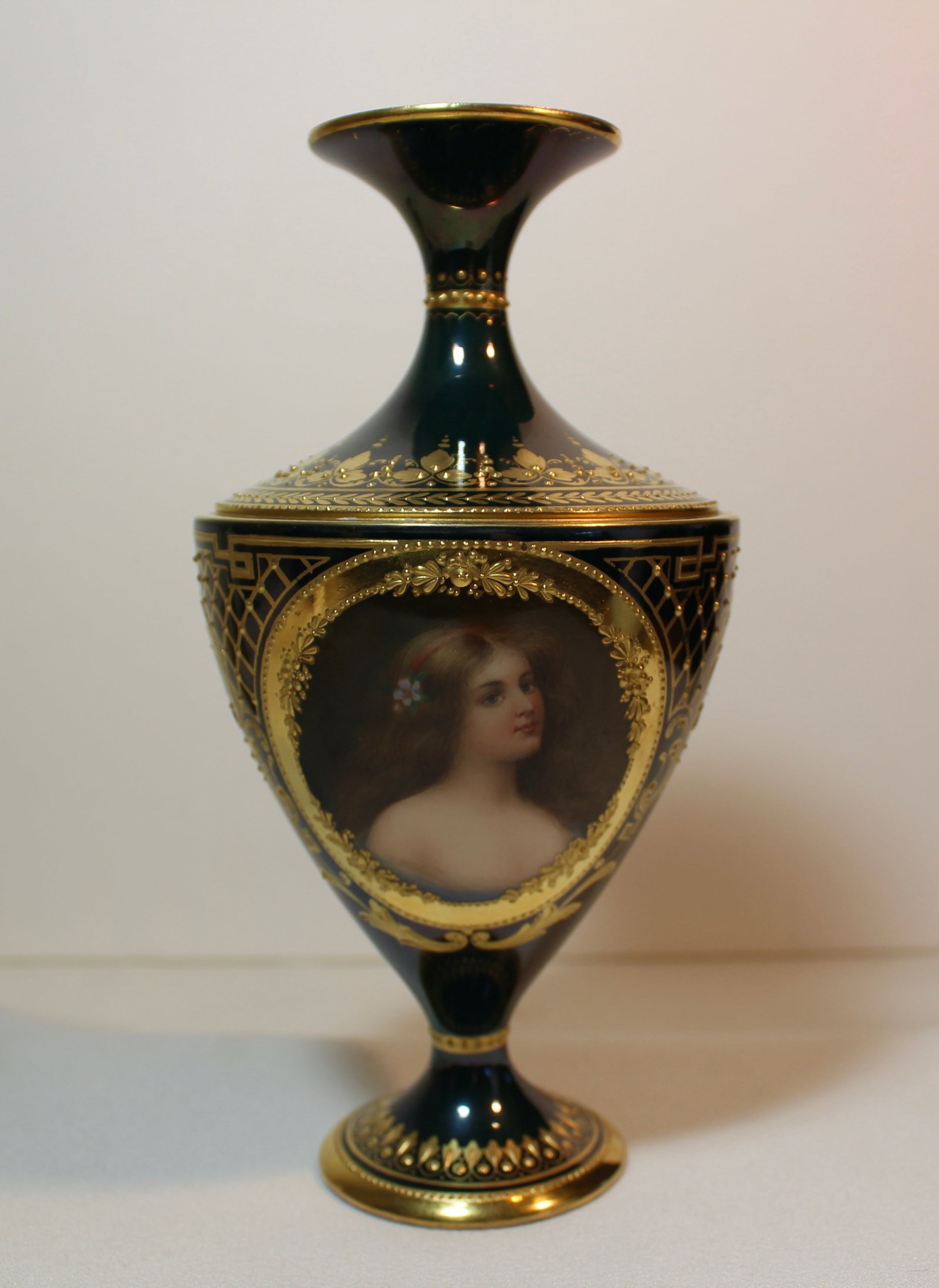 ROYAL VIENNA PORCELAIN PORTRAIT VASE: Fine antique Royal Vienna portrait vase hand painted with a portrait of a beautiful girl and decorated with elaborate gold gilding. H. 7 in.