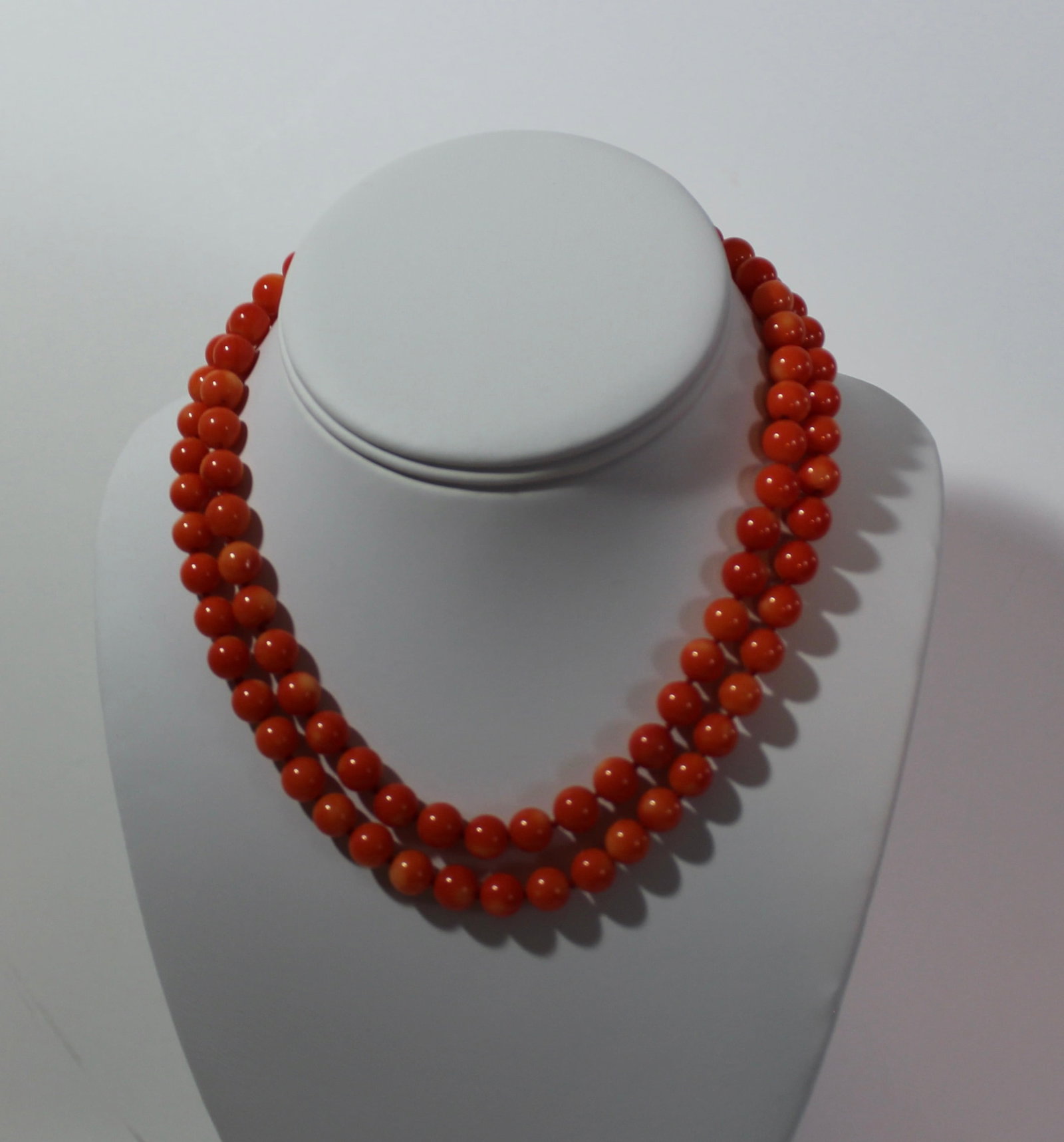 CORAL DOUBLE STRAND NECKLACE WITH 14k GOLD CLASP: Coral necklace having a double strand with 14k yellow gold clasp. Beads are a pretty vibrant orange with red hues. Beads 5mm and Weight around 60 grams.