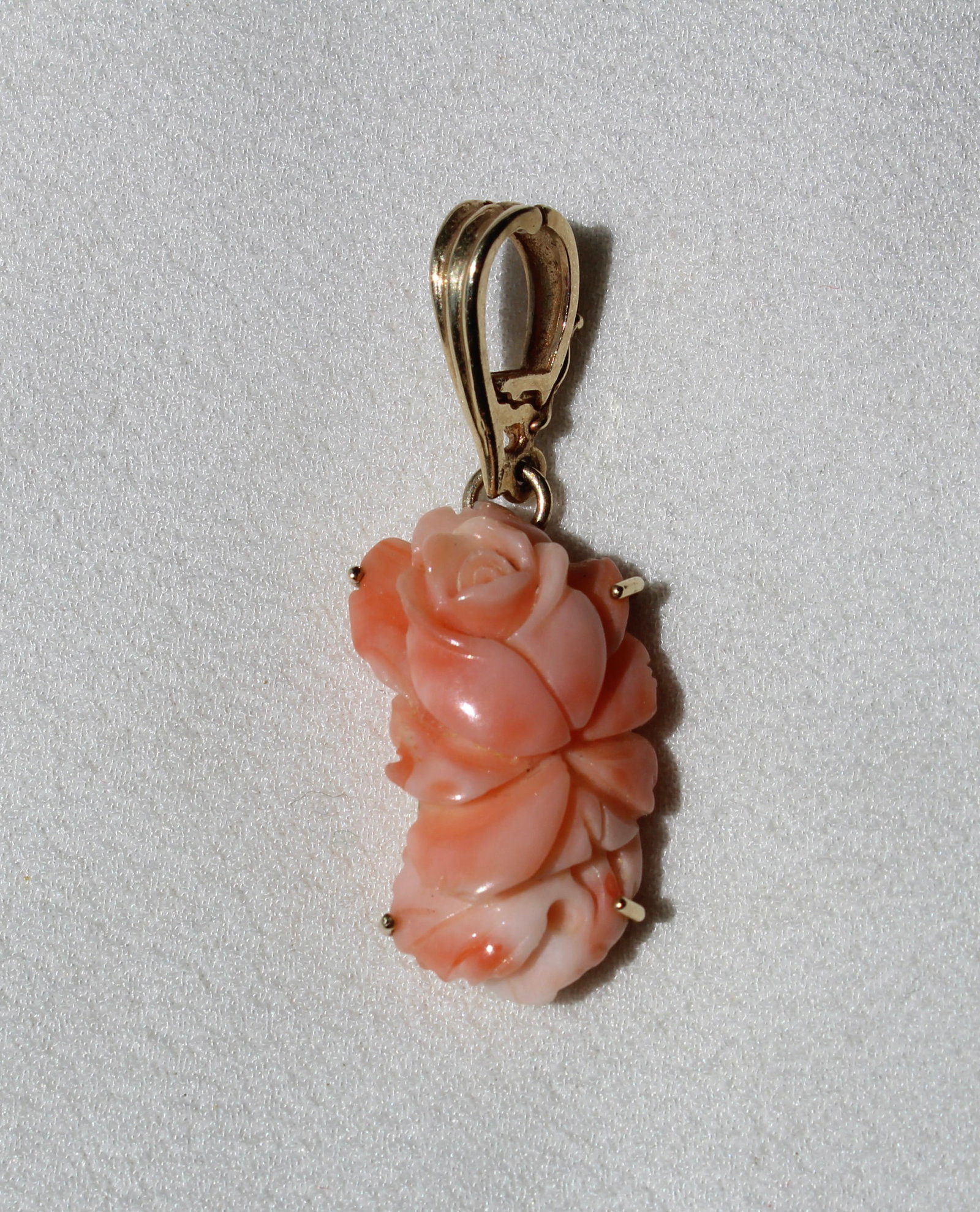14K GOLD CARVED CORAL FLOWER PENDANT: Quality carved coral flower set into a substantial yellow 14k gold setting.