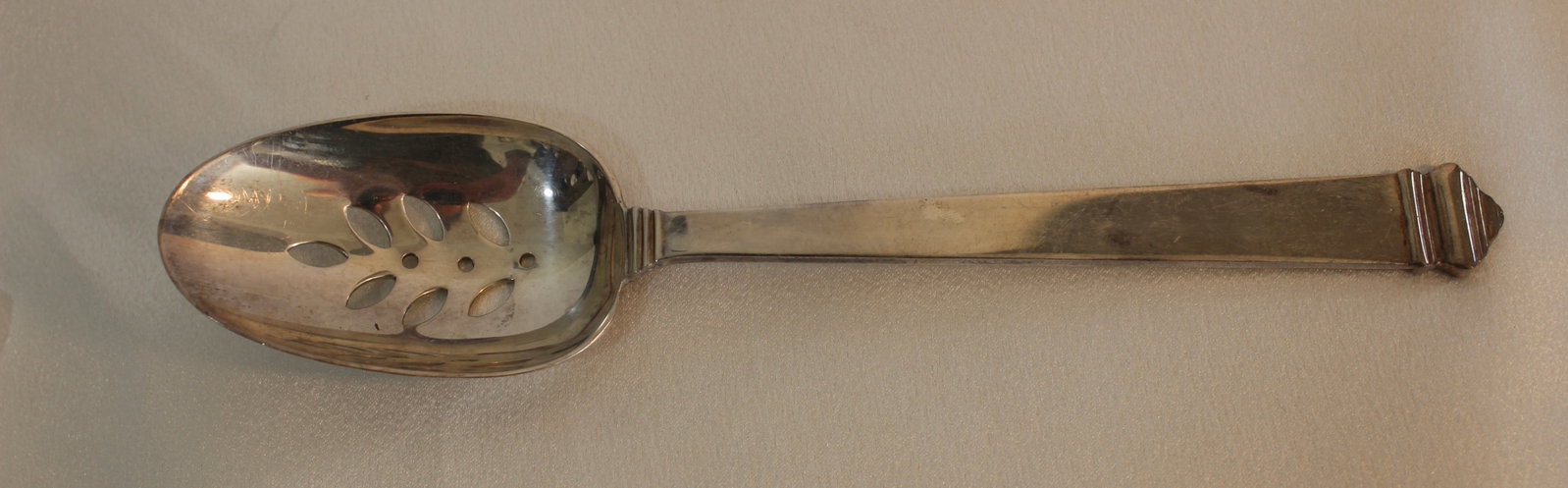 TIFFANY STERLING SILVER HAMPTON SERVING SPOON PERFORATED: Tiffany & Co. sterling silver Hampton flatware pattern serving spoon perforated. No monogram. 8.75 inches long.