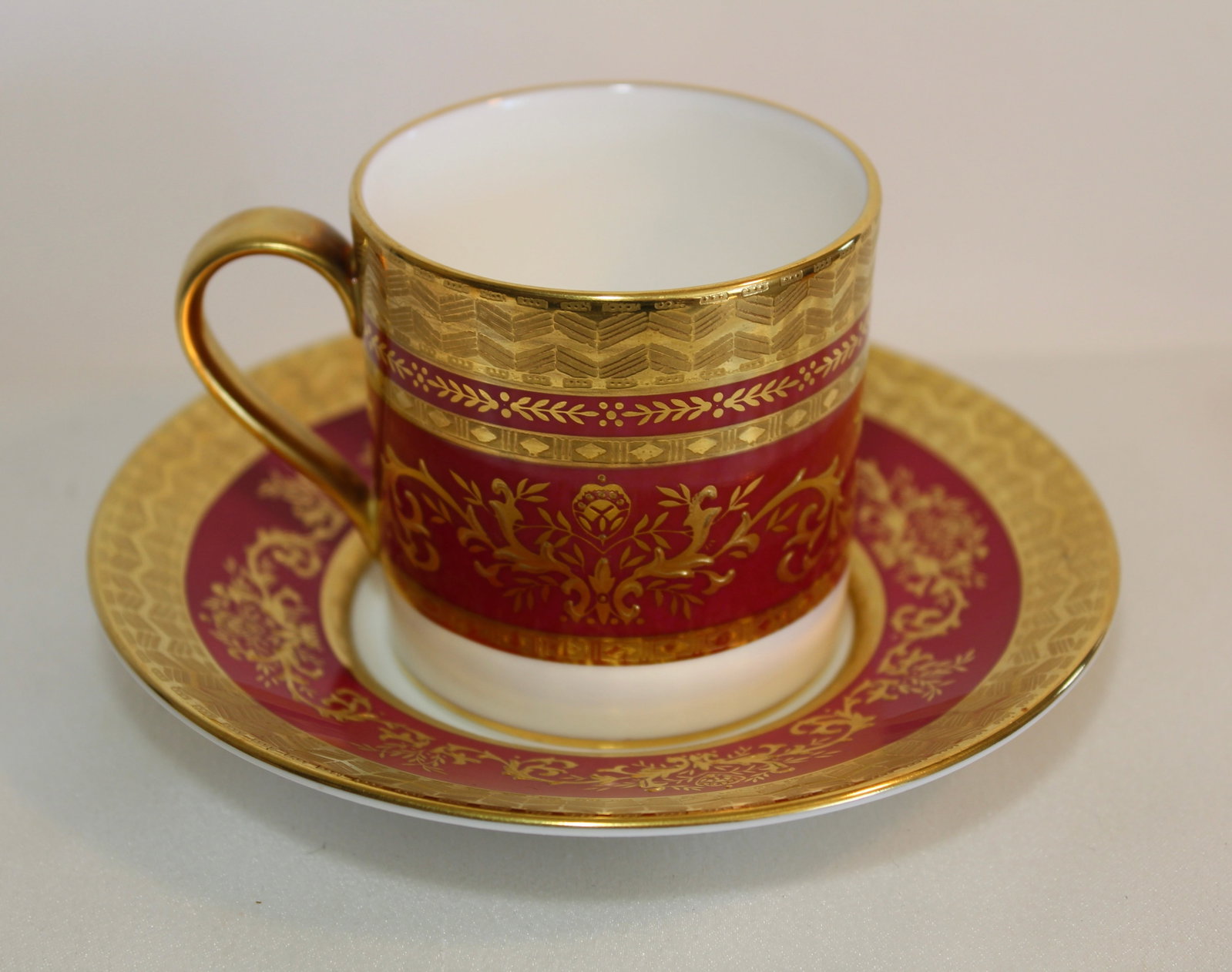 MINTON DEMITASSE CUP AND SAUCER: Antique Minton demitasse cup and saucer with elaborate gold decoration. Titled Atlantis on the bottom.