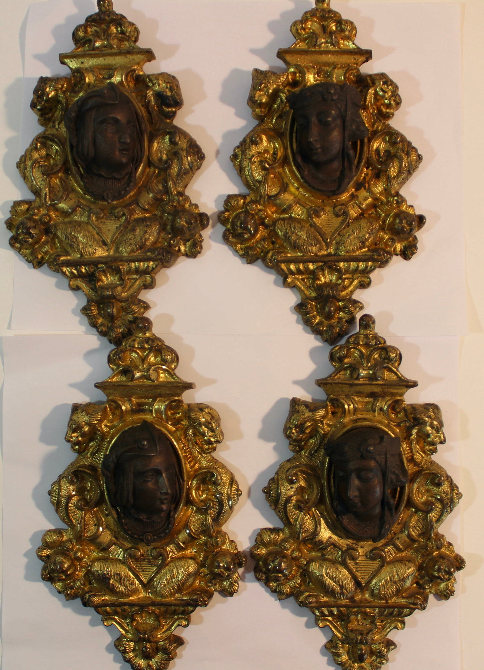 LOUIS XVI ORMOLU SET OF 4 WALL HEAD MOUNTINGS: Antique set of 4 French Louis XVI style wall head ornaments in gilt and patinated bronze. 19th century. L 8 inches each.