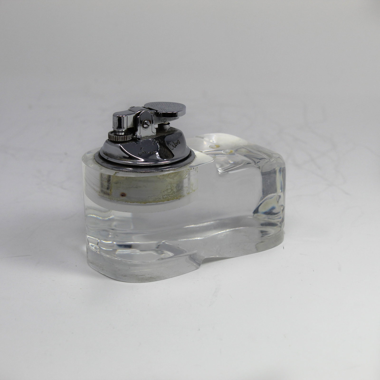 Shoe Shaped Crystal Table Lighter: Crystal table lighter cut in the shape of a shoe. Does not work just use as a decorative object.