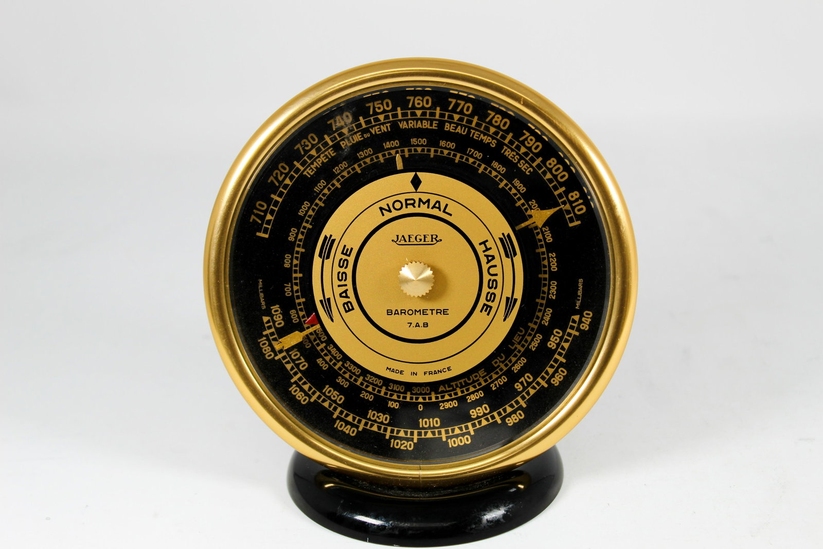 JAEGER ALUMINUM, STEEL AND GLASS BAROMETER: Made by Jaeger, circa 1950's. Rare, smaller version, with black-lacquered metal base, signed dial with a millimeter scale and altitude adjustable to 1500 meters, air pressure calibration screw on the 