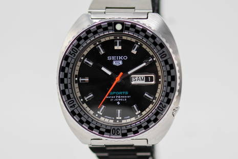 Seiko 5 Sports 21 Jewels with Day and Date Wristwatch: Stainless Steel Seiko 5 Sports 21 Jewels with Day and Date Wristwatch on Stainless Steel Seiko bracelet; Serial # 021039. 42mm diameter. Running at time of cataloging,