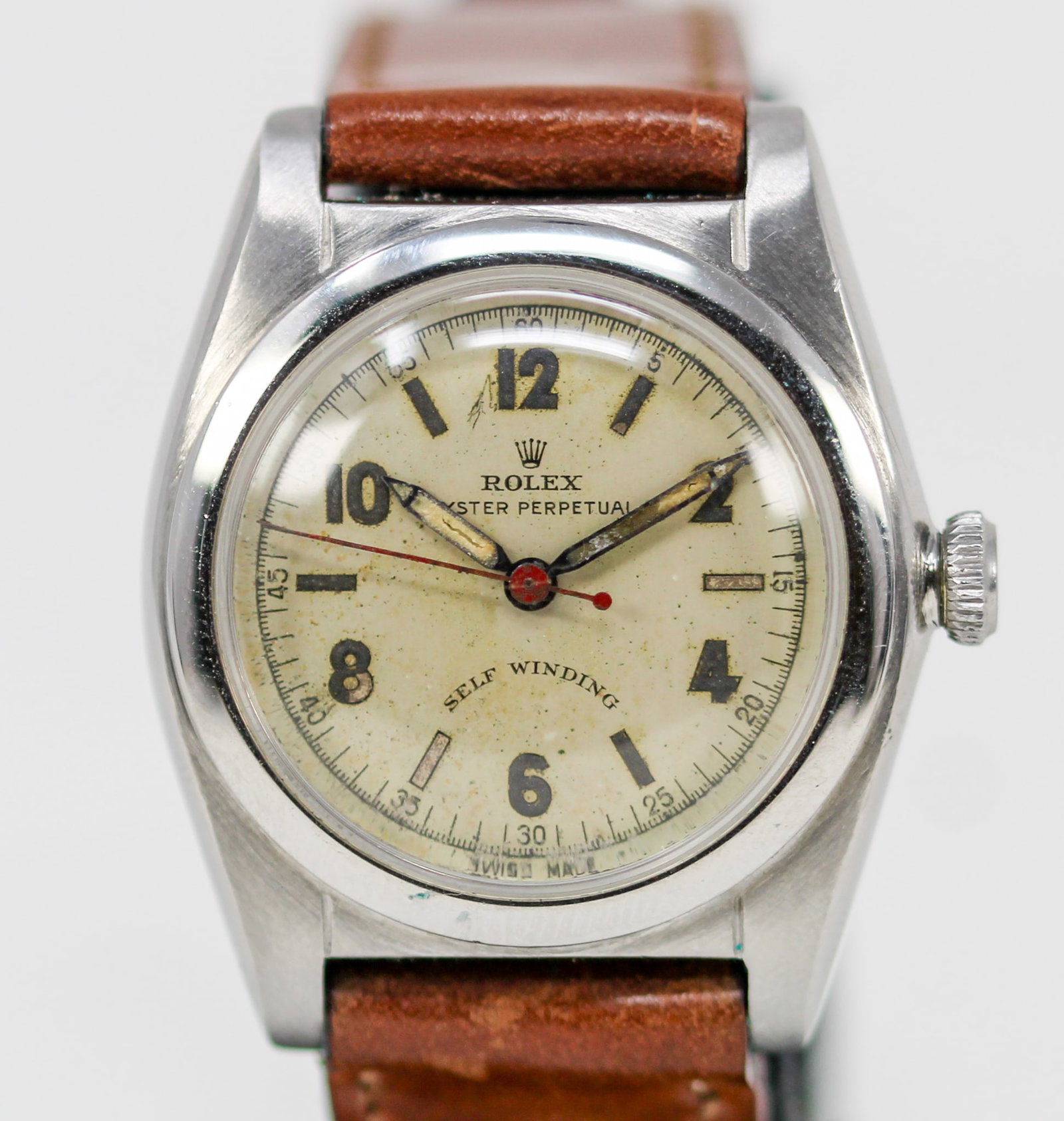 Vintage Rolex Oyster Perpetual Wristwatch: Stainless Steel Vintage Rolex Oyster Perpetual Wristwatch on Aftermarket Leather Strap; Model 2940, Serial # 310383. 32mm diameter. Running at time of cataloging. PLEASE NOTE: all wristwatches are sol