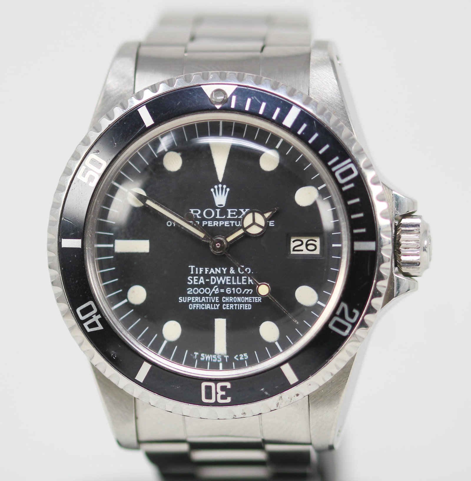 Vintage Rolex Oyster Perpetual Date "Tiffany & Co." Sea-Dweller Wristwatch: Stainless Steel Vintage Rolex Oyster Perpetual Date "Tiffany & Co." Sea-Dweller Wristwatch on Stainless Steel Rolex Bracelet; Model 1665, Serial # 6760965. 40mm diameter. Running at time of cataloging