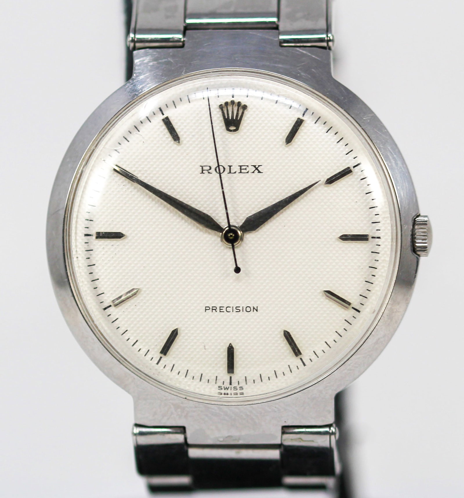 Vintage Rolex Precision Wristwatch: Stainless Steel Vintage Rolex Precision Wristwatch on Stainless Steel Rolex Bracelet; Model 9083, Serial # 257826. 36mm diameter. Running at time of cataloging. PLEASE NOTE: all wristwatches are sold