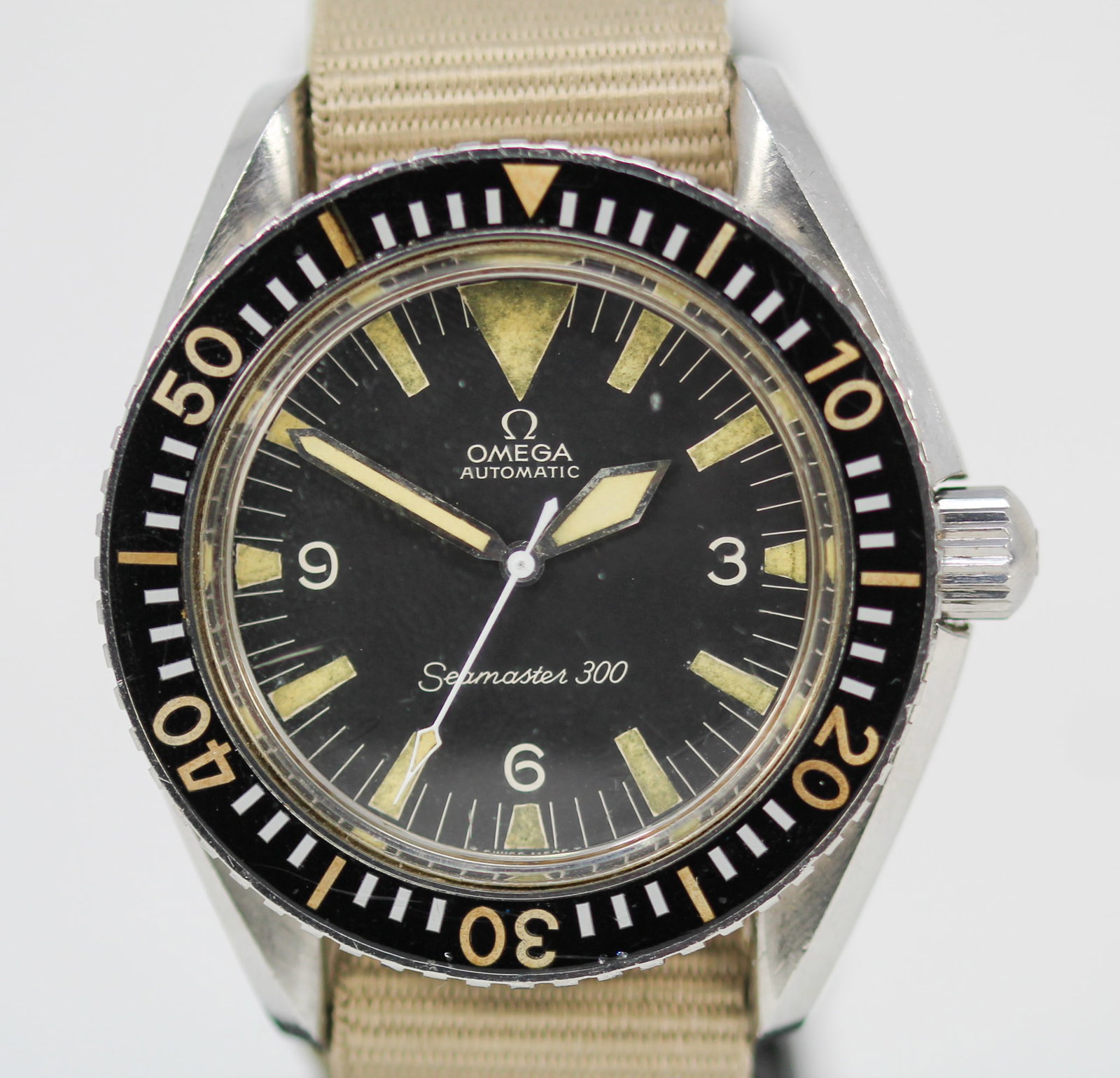 Vintage Omega Automatic Seamaster 300 Wristwatch: Stainless Steel Vintage Omega Automatic Seamaster 300 Wristwatch on Aftermarket Cloth Strap; Ref 165.024, Serial # 26309958. 42mm diameter. Running at time of cataloging. PLEASE NOTE: all wristwatches