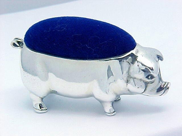 STERLING SILVER PIN CUSHION OF A PIG SEWING GIFT: This STERLING SILVER Pin Cushion is in the shape of a PIG - and adorable pig at that! The piggie has navy blue velvet for your sewing pins and he (she) stands 1" in height and is 1 3/4" in length. Thi