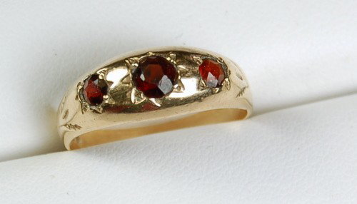 ANTIQUE GOLD RING GARNET ENGLISH HALLMARK: Antique English 9K Gold Ring featuring 3 Genuine GARNETS set across and into the band. This band has English Hallmarks inside the band and it is marked '375'. The Total Weight of the 3 GARNETS = .50 C