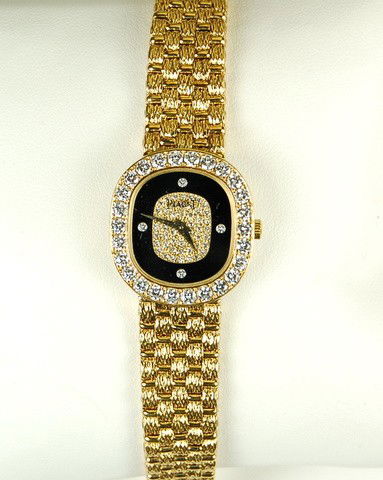 18K GOLD PIAGET WATCH DIAMOND: This PIAGET ladies wristwatch was purchased in 1992 at BUCHERER in Zurich Switzerland. It is 18K Yellow Gold and it is set with 26 VERY FINE DIAMONDS with a Total Weight = 1.39 CARATS! The watch is 6
