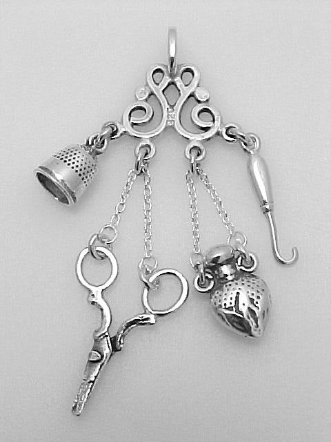 ANTIQUE STERLING SEW CHATELAINE PENDANT: STERLING Silver Chatelaine Pendant with Sewing Accessories mesuring approx. 3/4 inches W x 2 inches . This Sterling Pendant is a mini chatelaine with small thimble, scissors, perfume bottle and croche