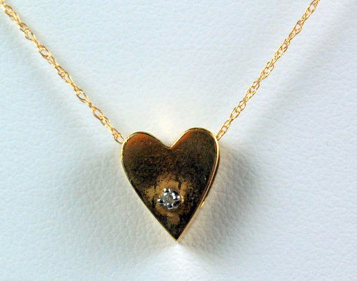14K GOLD SLIDE DIAMOND HEART 14K GOLD CHAIN NECKLACE: This 14k GOLD Heart shape SLIDE is set with a DIAMOND. The slide measures 3/8 inch across and it is suspended from a 14k Yelow Gold Chain 16 inches in length.