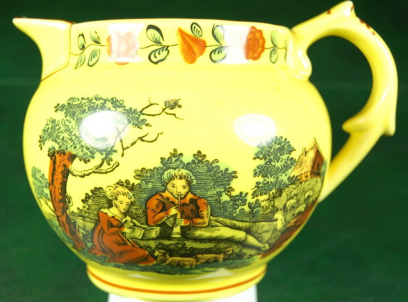 CERAMIC PITCHER MOTTAHEDEH PORTUGAL SMITHSONIAN INSTITU: This pitcher was sold by the SMITHSONIAN INSTITUTION. It was adapted and copied from a 19th Century British Pitcher. The scene on the front depicts a man courting a woman in the countryside with lambs