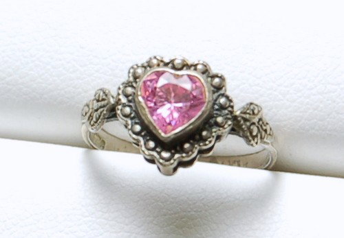 STERLING SILVER RING PINK HEART WITH MARCASITE: This STERLING SILVER ring features a HEART shape PINK stone surrounded by MARCASITES. The ring is a Size 6 1/4 and it can be resized.