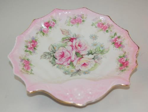 ANTIQUE NIPPON DISH PINK ROSES GREEN MARK: This Handpainted NIPPON dish measures 6 inches across. The markings on the back are of a green wreath with a flower within. The Plate is rimmed in pink with pink roses in the center.
