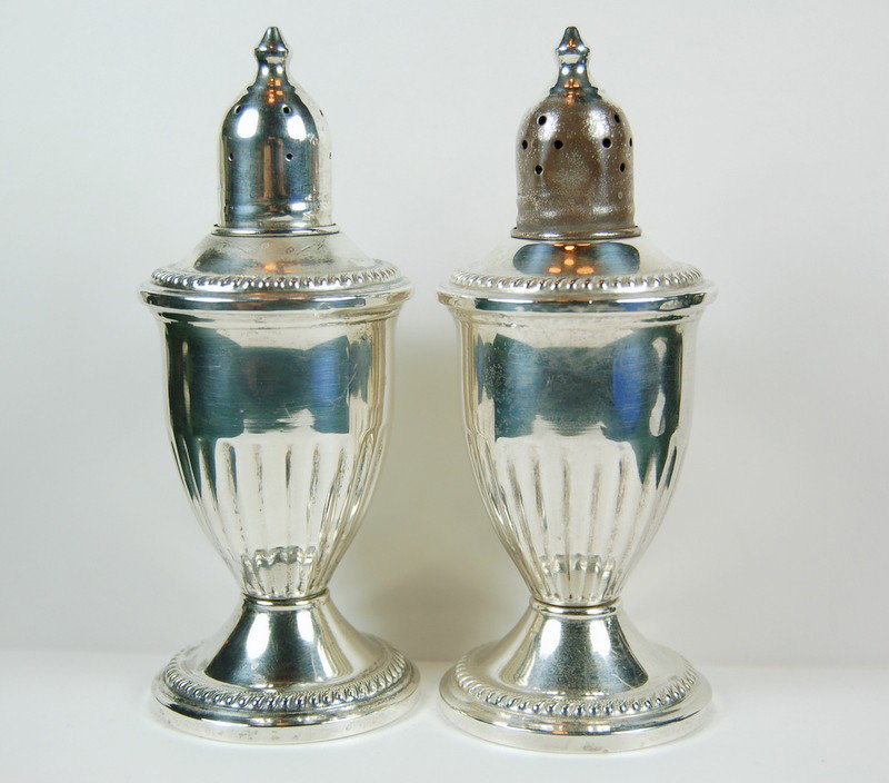 ANTIQUE STERLING SILVER SALT PEPPER SHAKER: This is a pair of ANTIQUE STERLING SILVER Salt and Pepper Shakers. They have glass liners and weighted bases, and they are 4.5 inches in height. The Salt Shaker has a dent at the top near the holes.