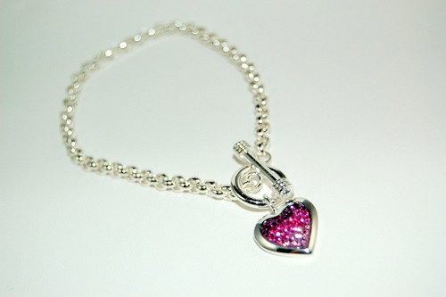 STERLING SILVER BRACELET PINK HEART CHARM: This beautiful STERLING SILVER Bracelet features oval looks (looks like a paper chain) and has a toggle style clasp which makes it very easy to get on and off. There is a lovely HEART shaped Charm dan
