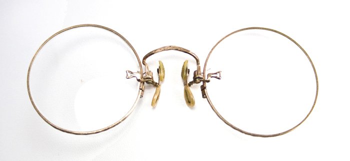 ANTIQUE PAIR OF SHURON PINCE NEZ EYEGLASSES CIRCA 1900: This ANTIQUE pair of Gold colored SHURON PINCE NEZ EYEGLASSES is Circa 1900. Pince nez eyeglasses have no arms and so they clip on to the nose. Therefore - the name Pince nez which in French means â�