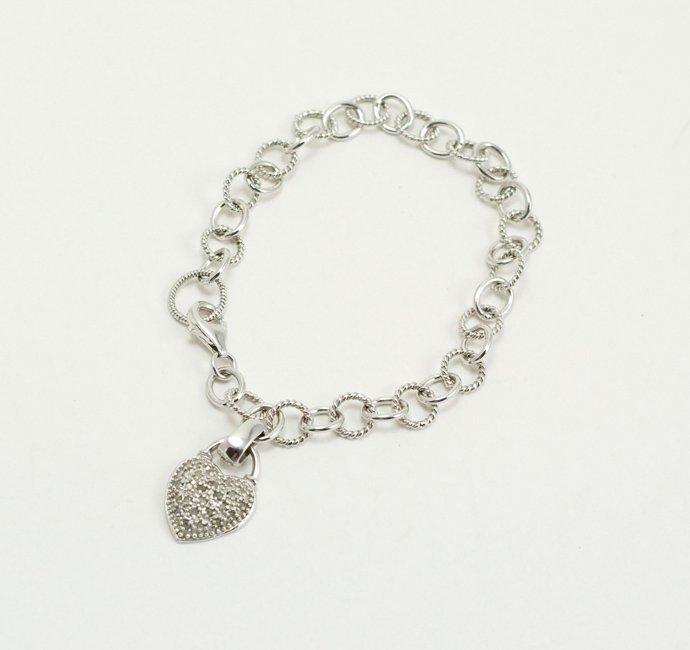 STERLING SILVER BRACELET WITH STERLING HEART CHARM WITH: This STERLING SILVER Bracelet is 7 inch in length and features a Heart shape Charm set with sparkling clear stones. The Heart measures 7/8 inch from top to bottom.
