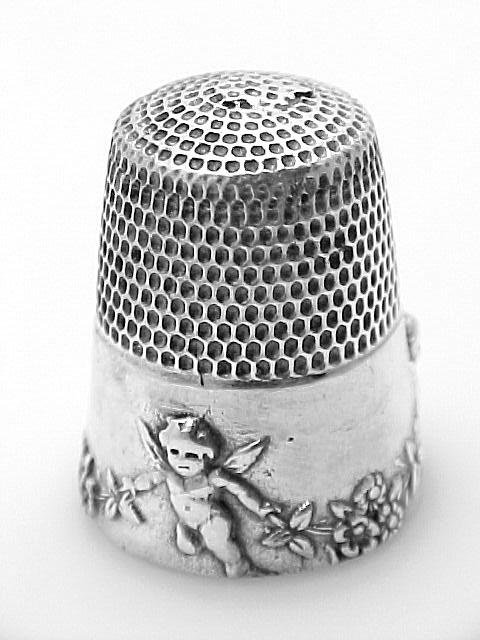 ANTIQUE STYLE STERLING SILVER SEWING THIMBLE w CHERUB: This Antique Style Sewing Thimble is an Authentic and Accurate copy of a Thimble from the 1930's. It is a SOLID STERLING SILVER THIMBLE with a Cherub design. It is 7/8 inch in height and the bottom di