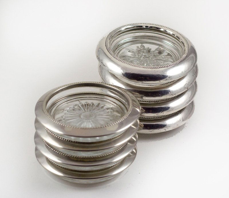 8 ANTIQUE STERLING SILVER RIMMED COASTER: Two sets of 4 VINTAGE STERLING SILVER Rimmed Coasters - one set is marked STERLING and one set is not marked. They each measure 4 inches across.There are 8 STERLING SILVER rimmed Coasters in all!