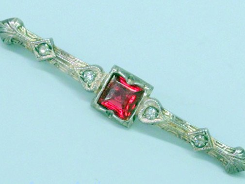 ANTIQUE BAR PIN RUBY COLOR STONE STERLING SILVER: This ANTIQUE STERLING SILVER Bar Pin is 2 inches in length and it features a Ruby colored stone and 2 white stones each side. It is a real treasure from long ago.
