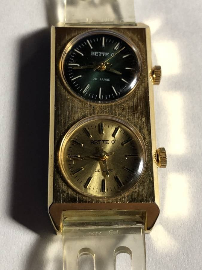 Vintage "Bette-O" Dual Face Wristwatch w/Silicone Band: Vintage "Bette-O" Dual Face Wristwatch with Silicone Watch Band Preowned from an Estate. This Watch is not a Quartz but a Wind-up and 1 Watch is Overwound and Needs Repair. Shipping $5.00