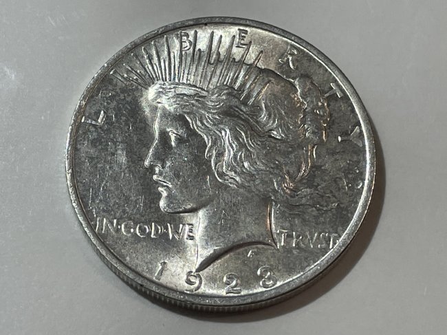 1923-P Almost Uncirculated Peace Silver Dollar as Pictured. (1 of 2)