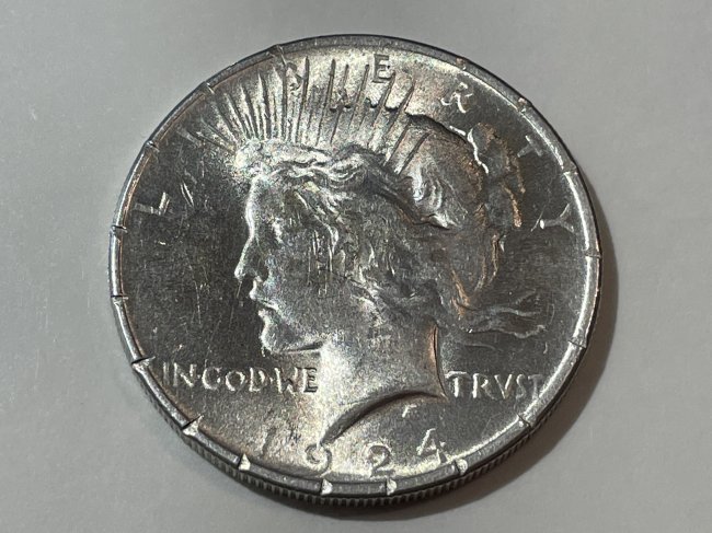1924-P Almost Uncirculated w/Rim Nicks Issues Peace Silver Dollar as Pictured. (1 of 2)