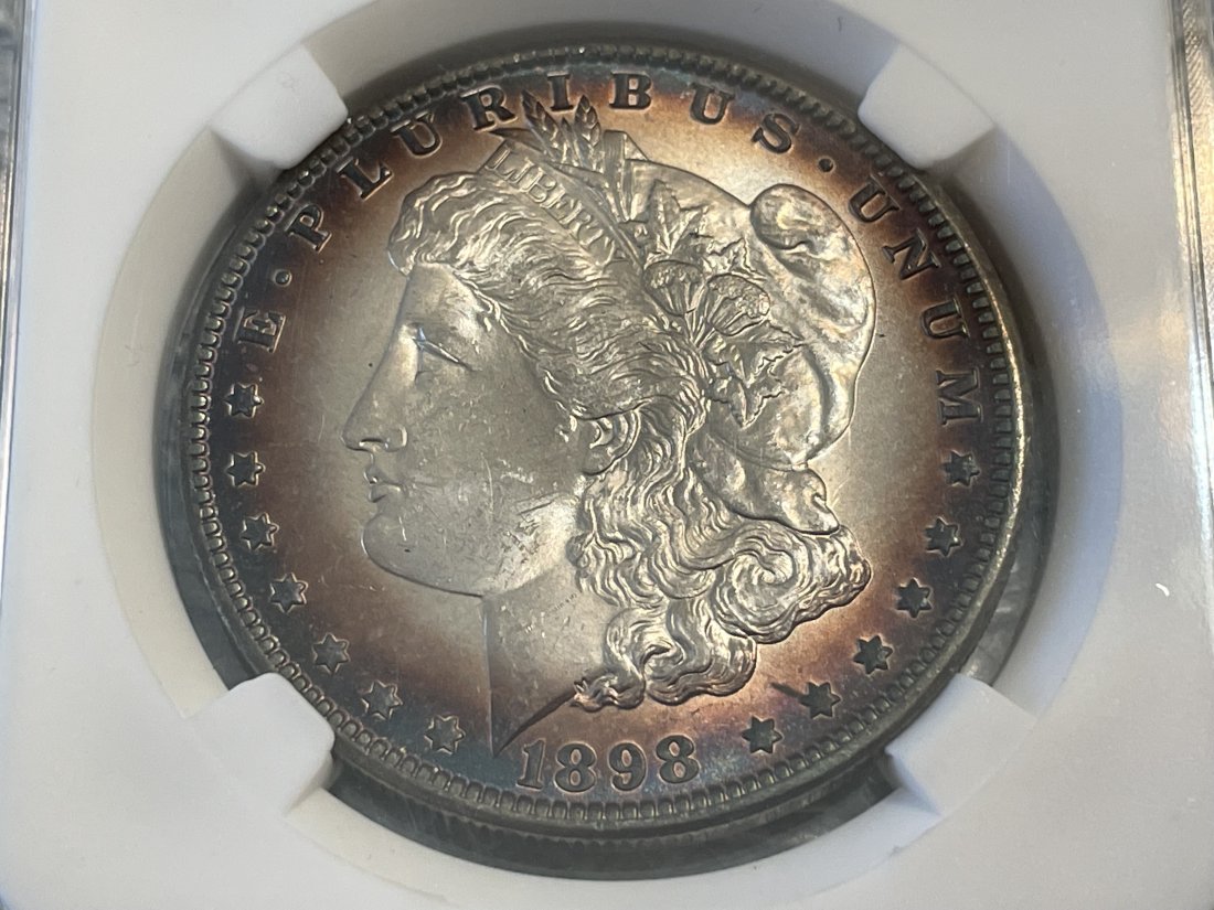 1898-0 SPIKED CHIN & LIP SUPERB OBVERSE TONED UNCIRCULATED MORGAN SILVER DOLLAR: 1898-0 SPIKED CHIN & LIP SUPERB OBVERSE TONED UNCIRCULATED MORGAN SILVER DOLLAR PREOWNED FROM AN ESTATE. $5 DOMESTIC SHIPPING. FOR MULTIPLE LOTS WON THE SHIPPING FEE WILL BE COMBINED OR ADJUSTED ACCOR