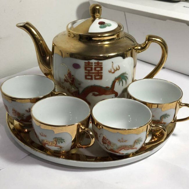 Vintage Chinese Red Phoenix & Red Dragon Tea Set Preowned from an Estate.: Vintage Chinese Red Phoenix & Red Dragon Tea Set. This includes 4 teacups with gold handles made of porcelain & one Tea Pot with lid. The cups are approximately 2 1/2 inches tall & the Tea Pot measure