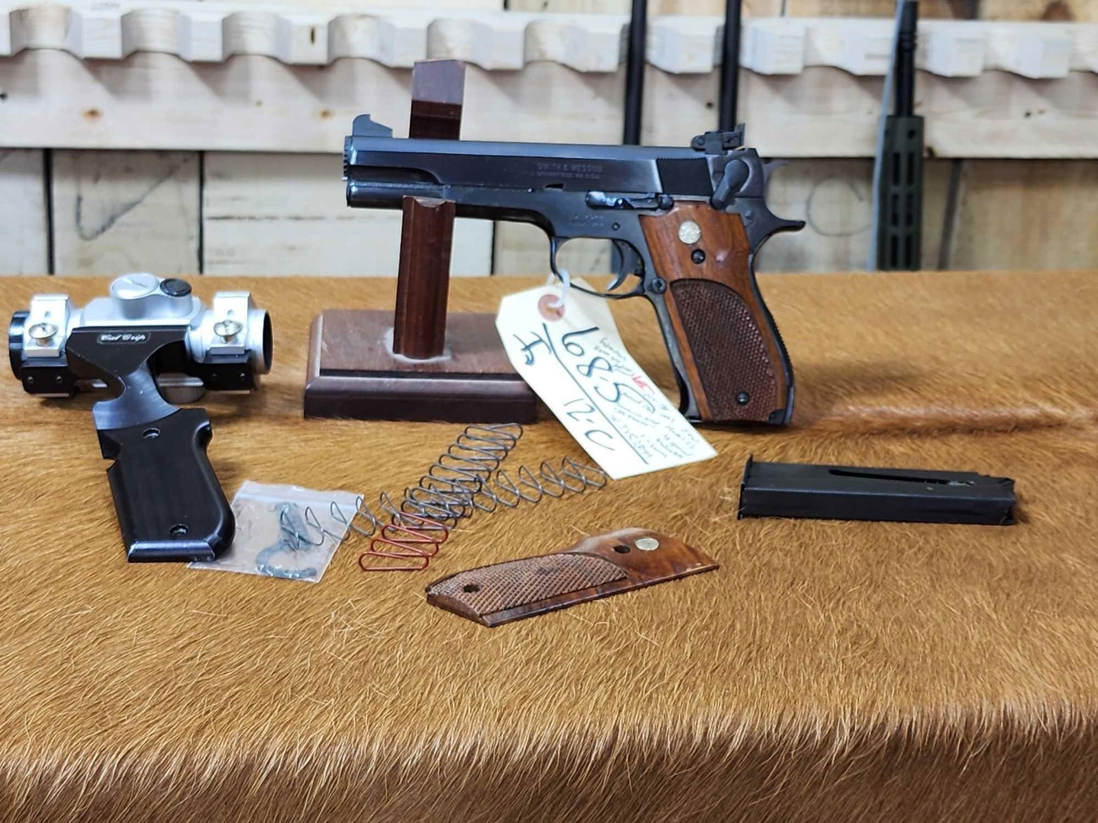 Smith & Wesson Model 52-2 .38 Special Wad Cutter Semi Auto Competition Pistol: 68.5 Mfg as a match target pistol very nice overall condition 5" barrel comes with Cal Grip scope mount with red dot sight, extra mag , extra grip more SN TVC2044