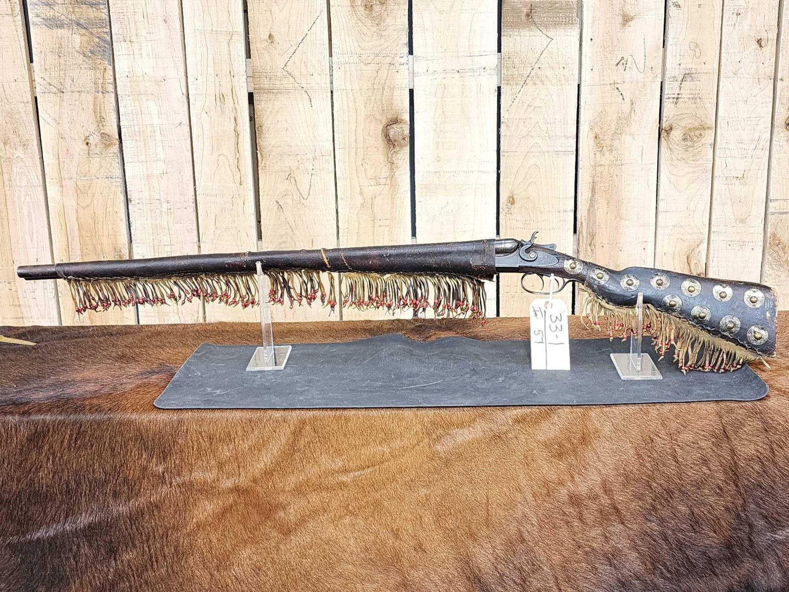 Antique Parker Brothers 12ga Double Barrel Shotgun: 33.1 Mfg 1886 no FFL required Cool vintage piece with vintage leather decorations Spotted stock with fringes leather trade beads vintage leather barrel sleeve fringed with trade beads 32" twist steel