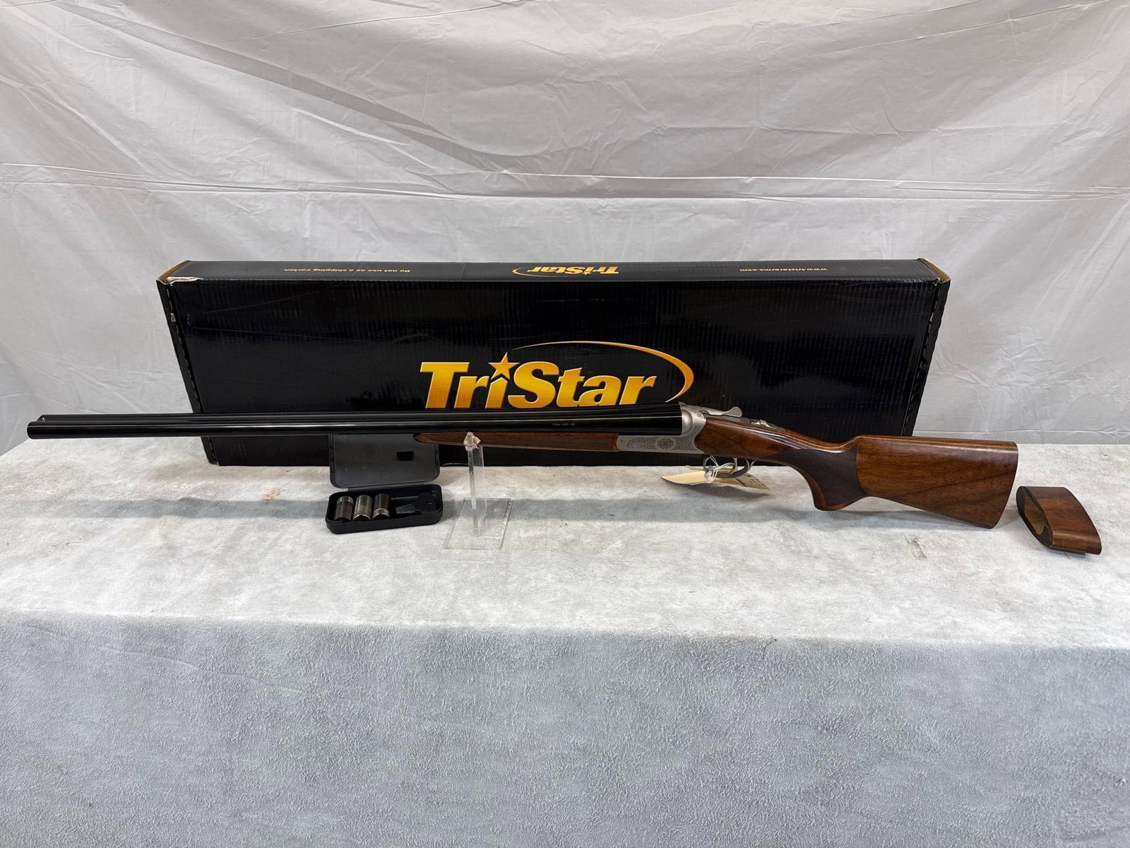TriStar Bristol Silver 3in 20 ga Over/Under Shotgun: 114.8 used stock been modified for youth hunter comes with what you see or needs replaced 28 inch barrels shinny bore comes with choke tubes and box sn 21TB2001145