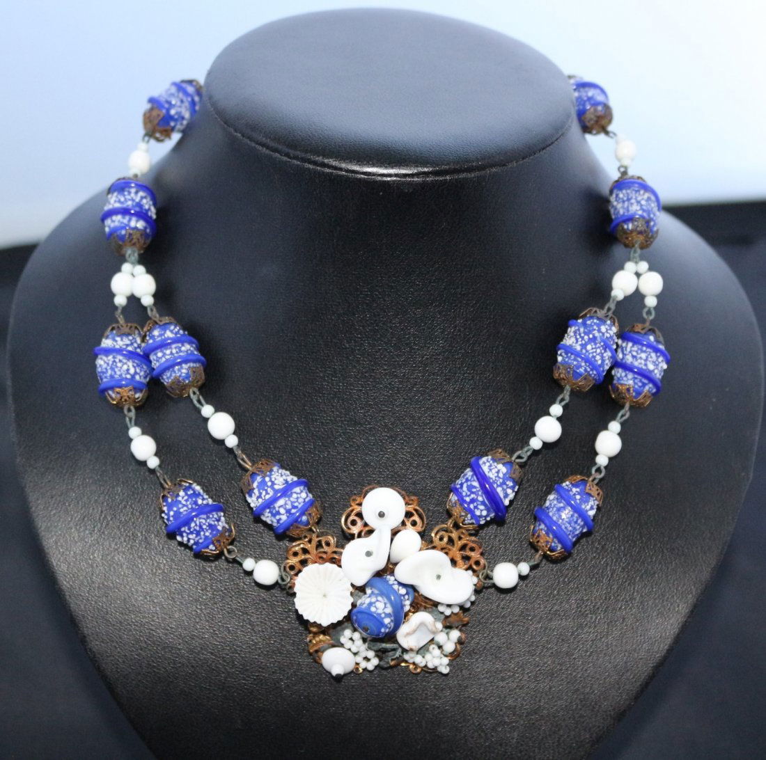 Ceramic Bead Decorative Necklace – Miriam Haskell?: Made up of several ceramic beads which have a speckled decoration on them and metal end caps on each, the central hanging pendant is made up of various flower shaped pieces, the reverse is a nicely sh