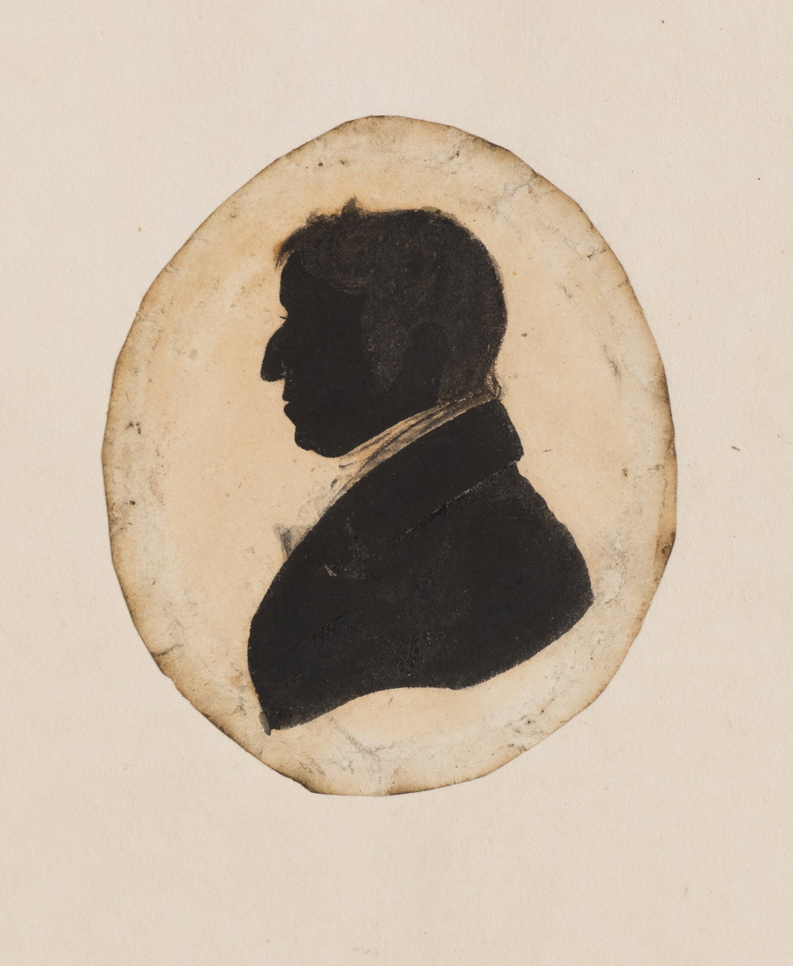Unknown (19th), Young man in a frock coat, Silhouette: Unknown (19th century): Young man in frock coat Male profile silhouette in oval medallion, facing left, 19th century, Silhouette Technique: Silhouette on Paper, mounted on Paper Date: 19th century Des