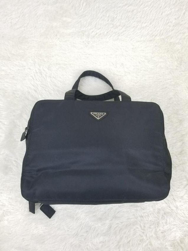 Prada Black Nylon Bag Organizer: Brand: Prada Material: Nylon Style: Organizer Color: Black Size(inch): W 12 x H 8 x Strap 4.25 Country of Origin: Italy Come with: - Rabbit's Habit items come with a 100% money-back authenticity guara