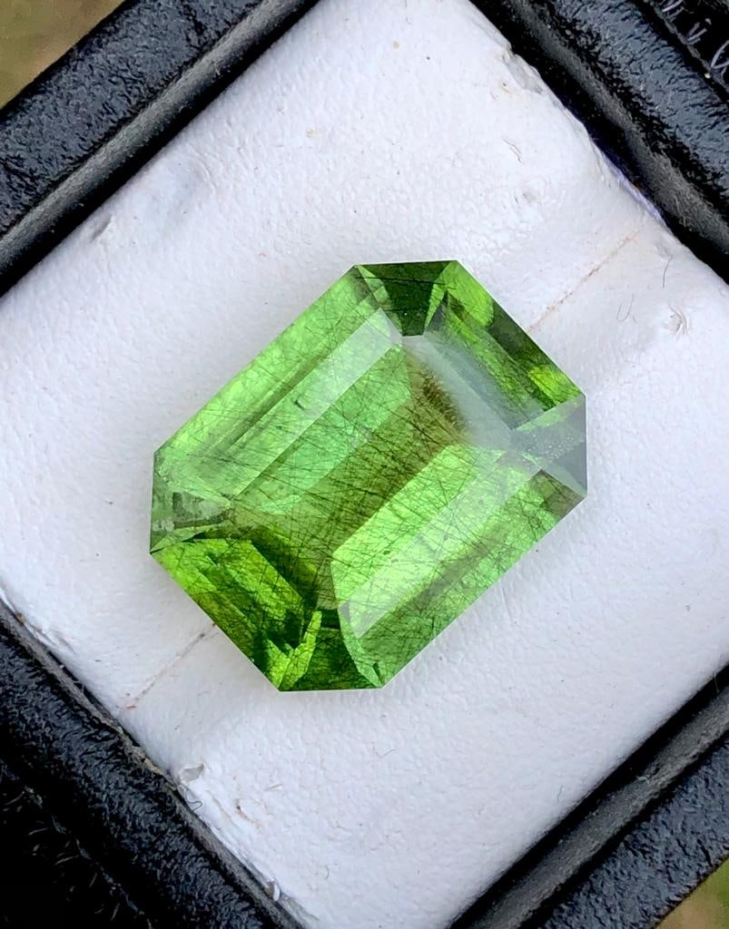 14.40 Carats Emerald Cut Natural Rutiled Peridot Gemstone - 18X14X8 mm: 14.40 Carats Emerald Cut Natural Rutiled Peridot Gemstone - 18X14X8 mm Shipping Rate: $15.00 .shipping rates are determined by Parcel weight and destination.Combined shipping: We offer combine shippin