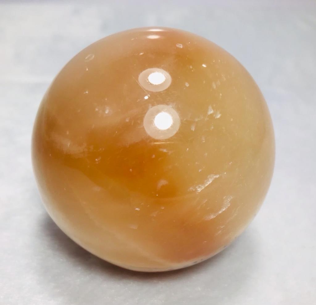 Honey Calcite sphere - Diameter - 363G: Honey Calcite sphere - Diameter 63mm - 363G Shipping: $45.00. Shipping rates are determined by Parcel weight and destination.