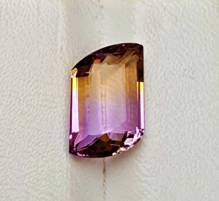 Bi-Color Ametrine Gemstone - 8 Carats: Bi-Color Ametrine Gemstone - 8 Carats - 15X11X7 mmShipping Rate: $15.00 .shipping rates are determined by Parcel weight and destination.Combined shipping: We offer combine shipping on multiple items p