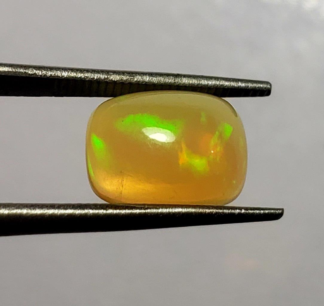 Fire Ethopian Opal - 1.5 Carats: Fire Ethopian Opal - 1.5 Carats - 10X8X5 mmShipping Rate: $15.00 .shipping rates are determined by Parcel weight and destination.Combined shipping: We offer combine shipping on multiple items