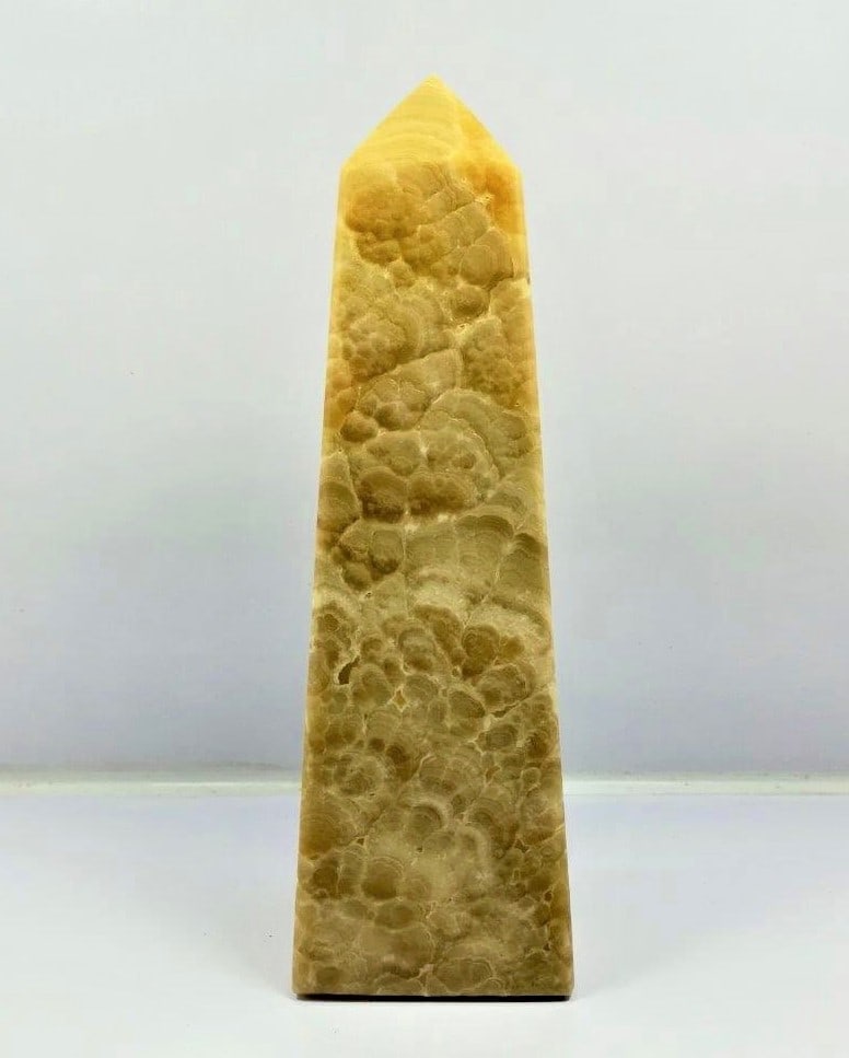 Honey Calcite tower - 647 Grams: Honey Calcite tower - 155X52X36 mm - 647 GramsShipping Rate: $55.00 .shipping rates are determined by Parcel weight and destination.Combined shipping: We offer combine shipping on multiple items purch
