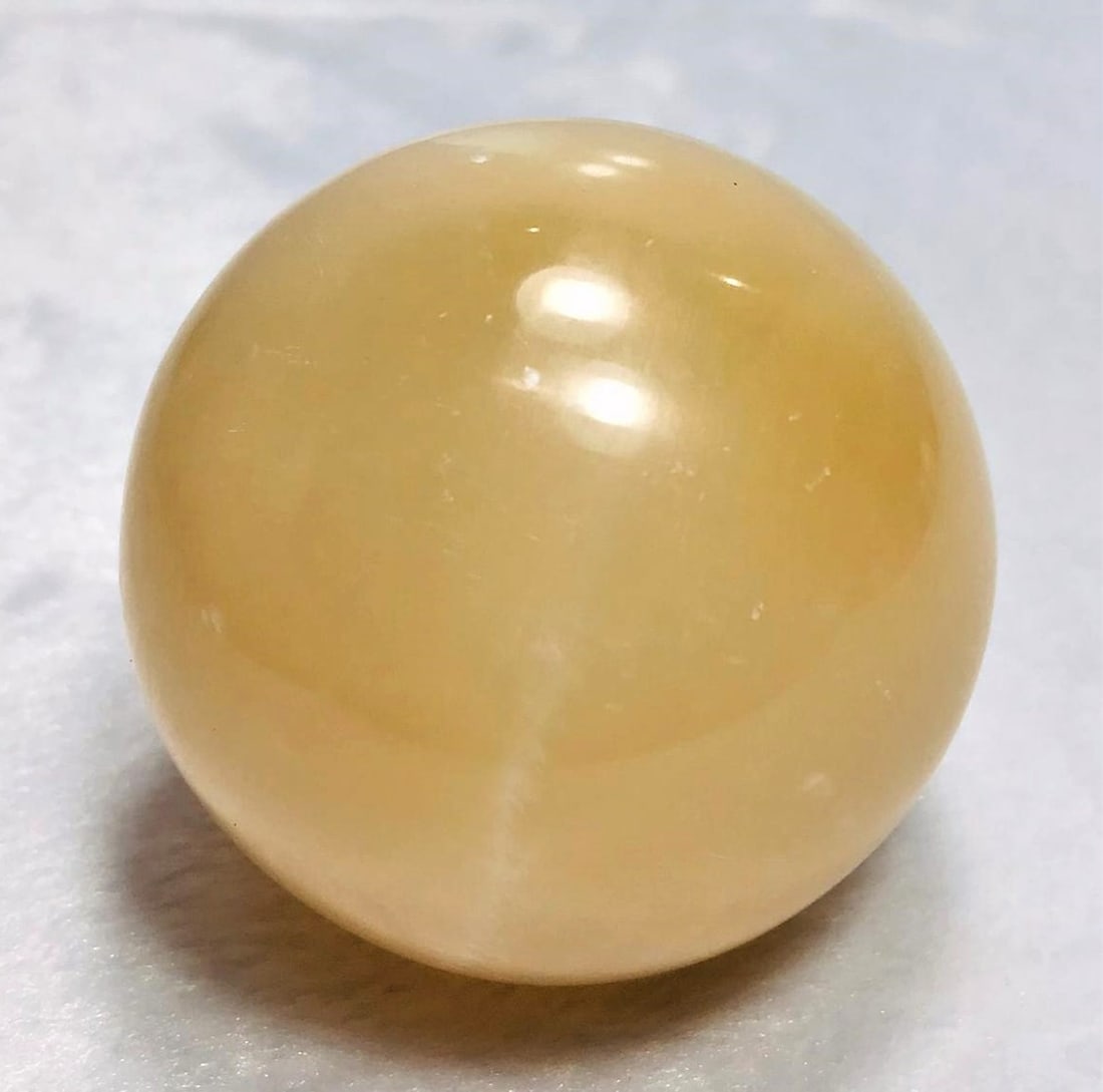 Honey Calcite Sphere round shape - 346G: Honey Calcite Sphere round shape - 62mm - 346G Shipping: $45.00. Shipping rates are determined by Parcel weight and destination.