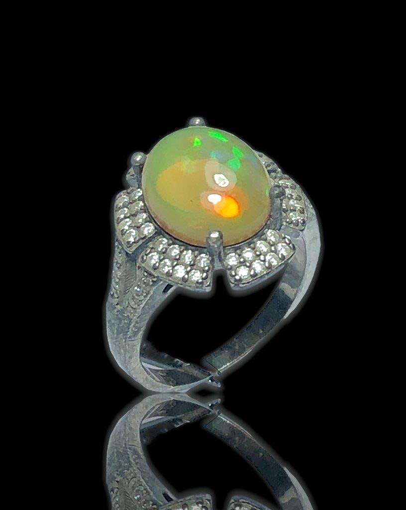 White Opal Ring in Silver: White Opal Ring in SilverStone Weight: 5 Carats Ring Size: 7 US (Adjustable)Ring Weight: 5.20 Grams Choose design of your own and we will make it for youWe accept custom order in Sterling Silver, Gold